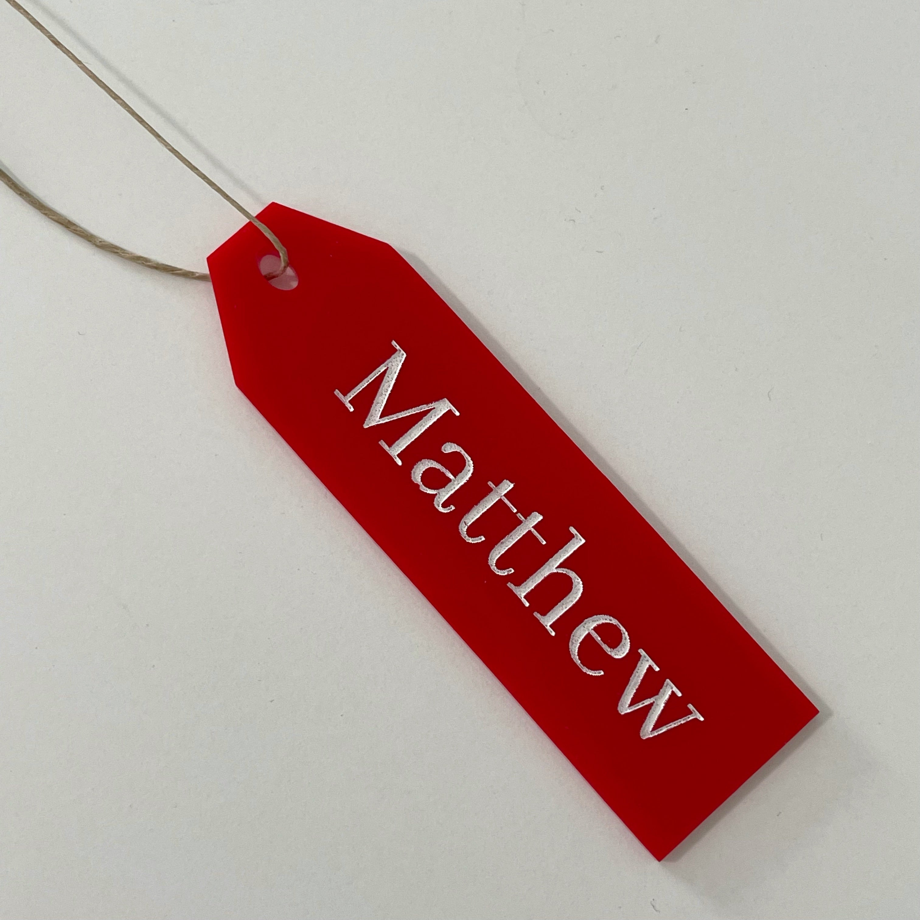 alt="red engraved acrylic personalized Christmas tags"